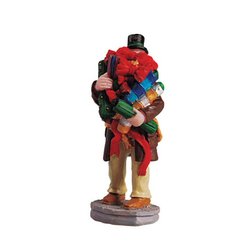 Statue of a person carrying a large bundle of colorful items on a white background