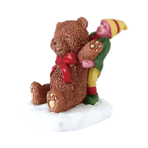 Decorative figurine of a bear being carried a boy on its back, set against a white background.