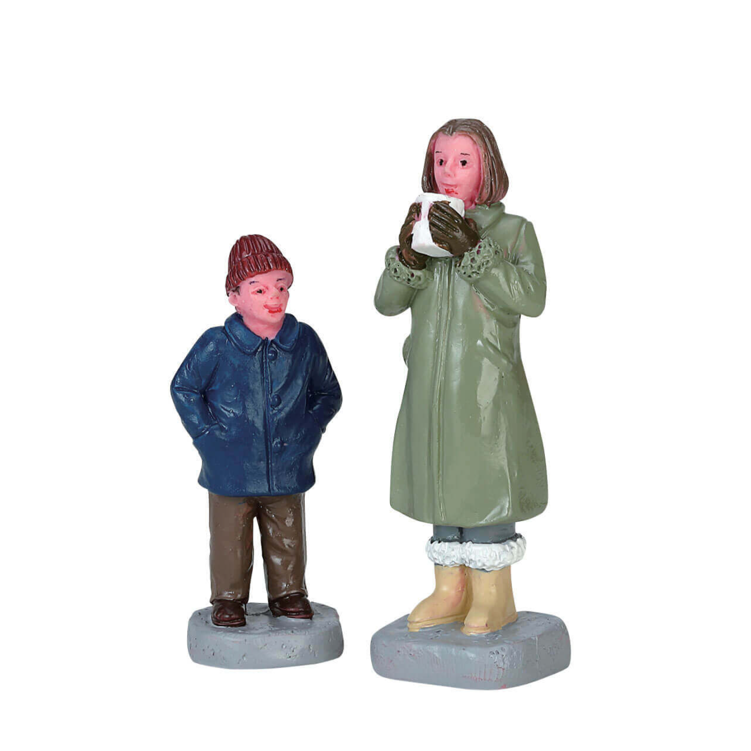 Two figurines of a boy and a girl in raincoats on white background