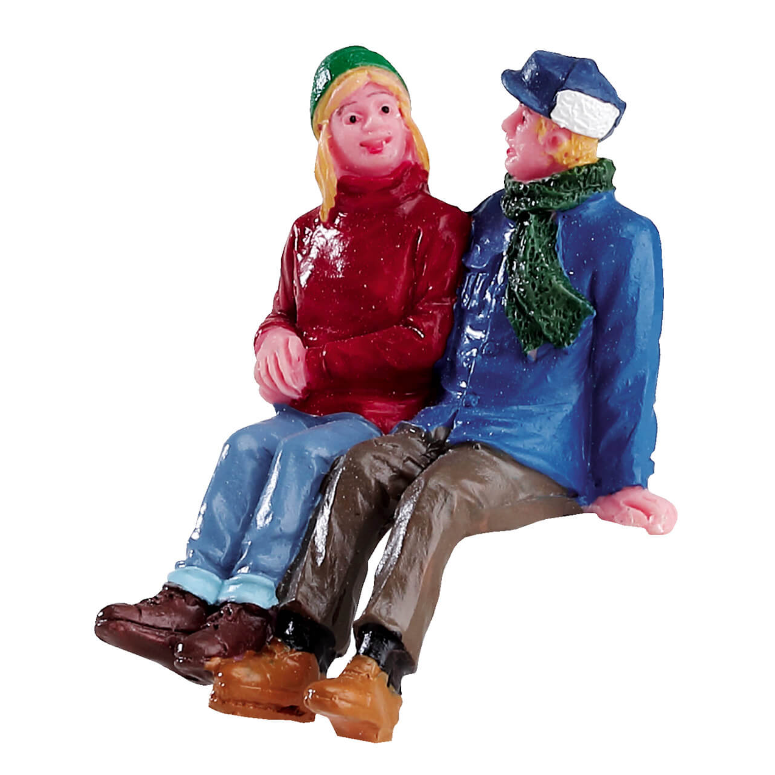 Two figurines of a man and woman sitting together on a white background