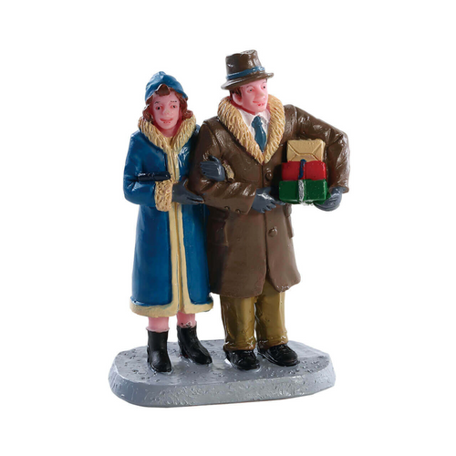 Figurine of two people in winter clothing with a gift, on a white background