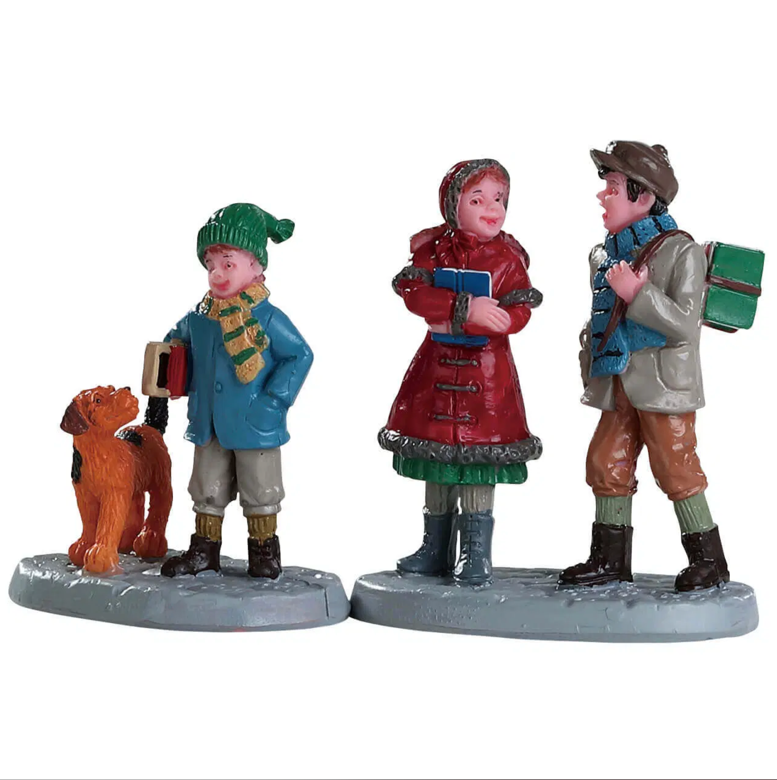 Three figurines in winter clothing with a dog on a white background