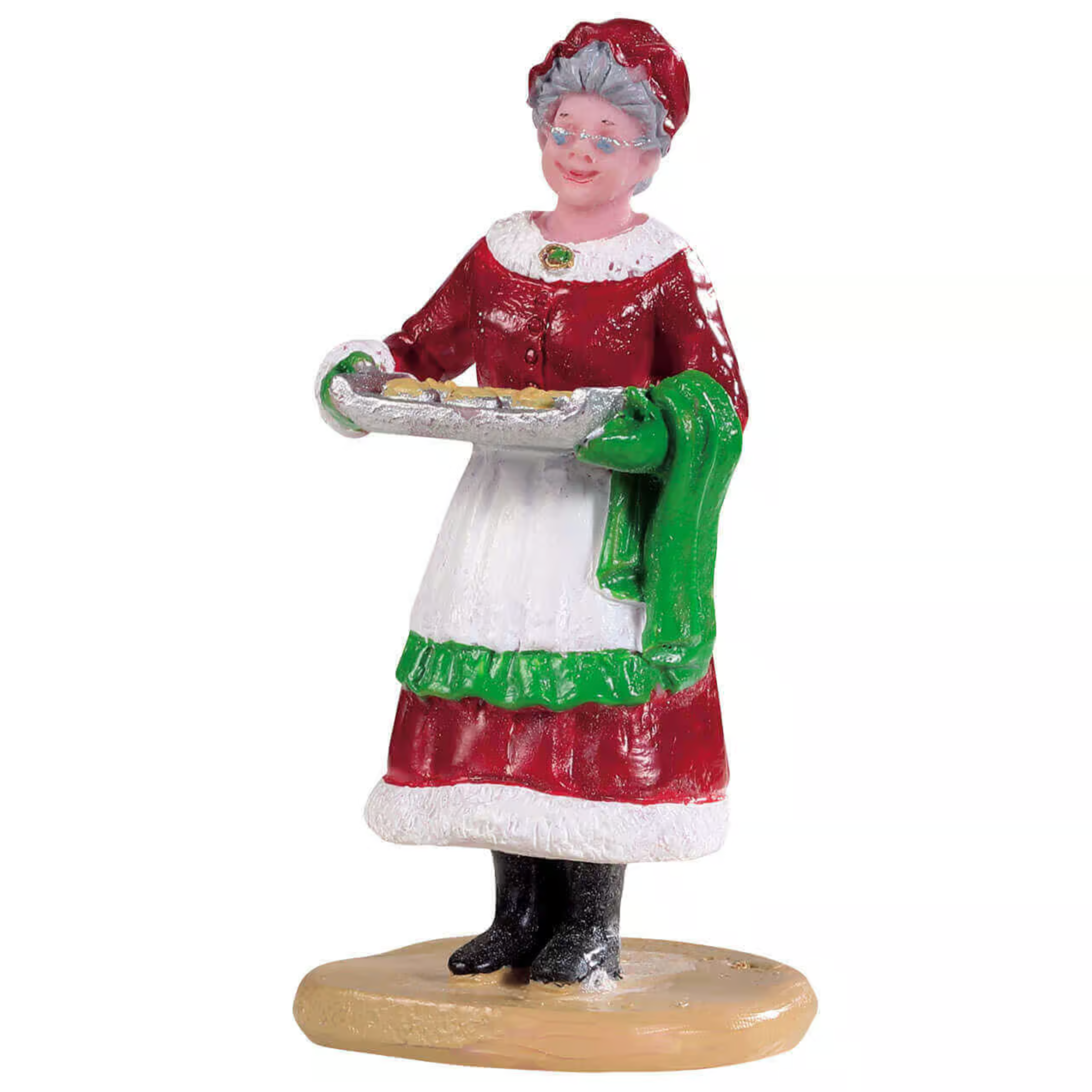 Figurine of a Mrs Clause in a red dress with a green apron holding a tray on a white background