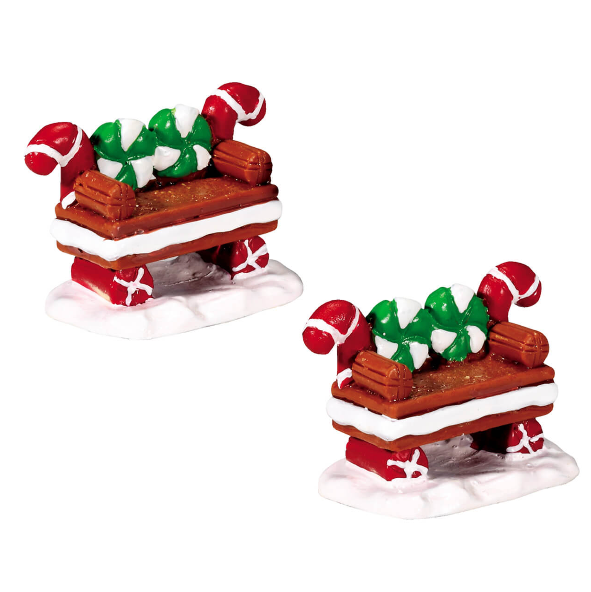 Two miniature candy cane cookie bench seats on a white background