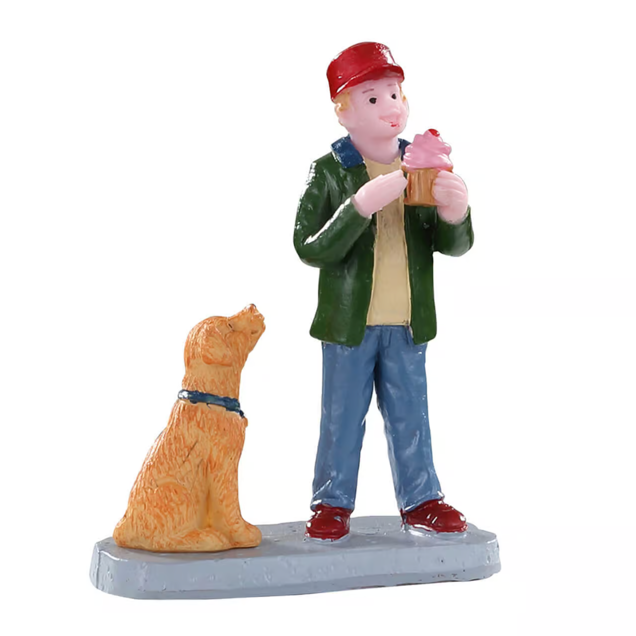 Figurine of a boy with a red cap and green jacket standing next to a dog, holding a cup.