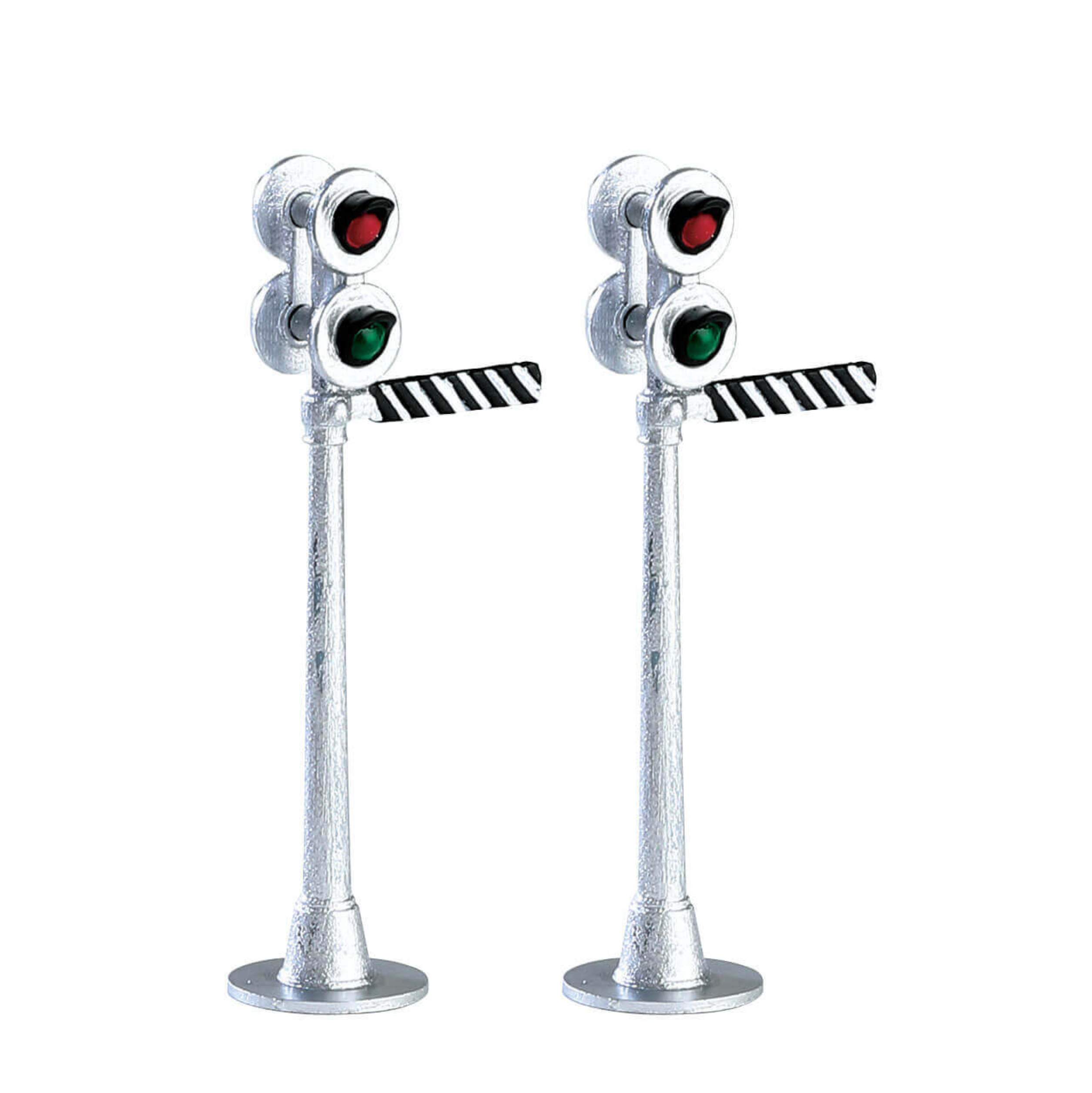 Two miniature traffic light models on stands with a white background