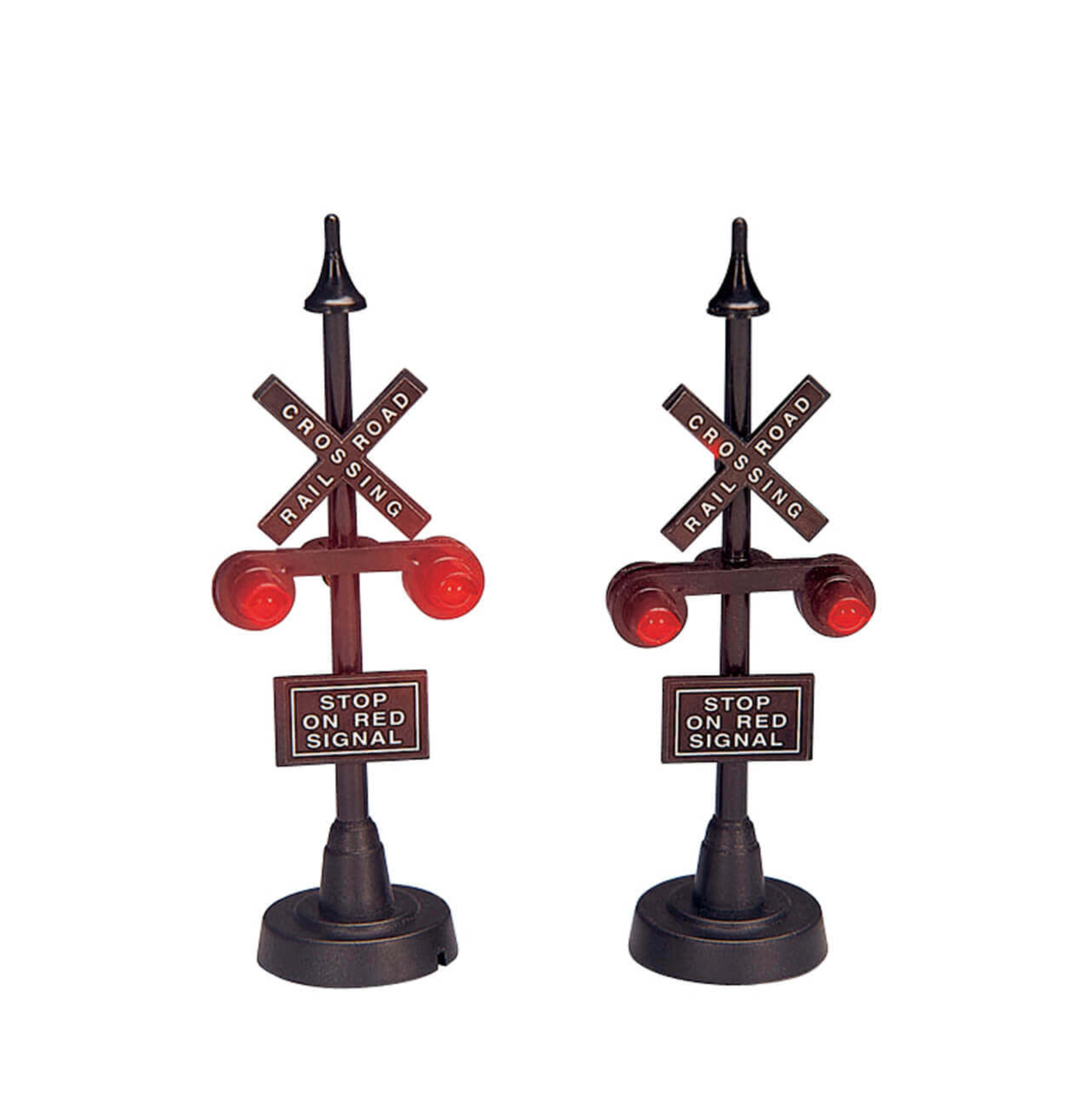 Two miniature Lemax  railroad crossing signals on a white background