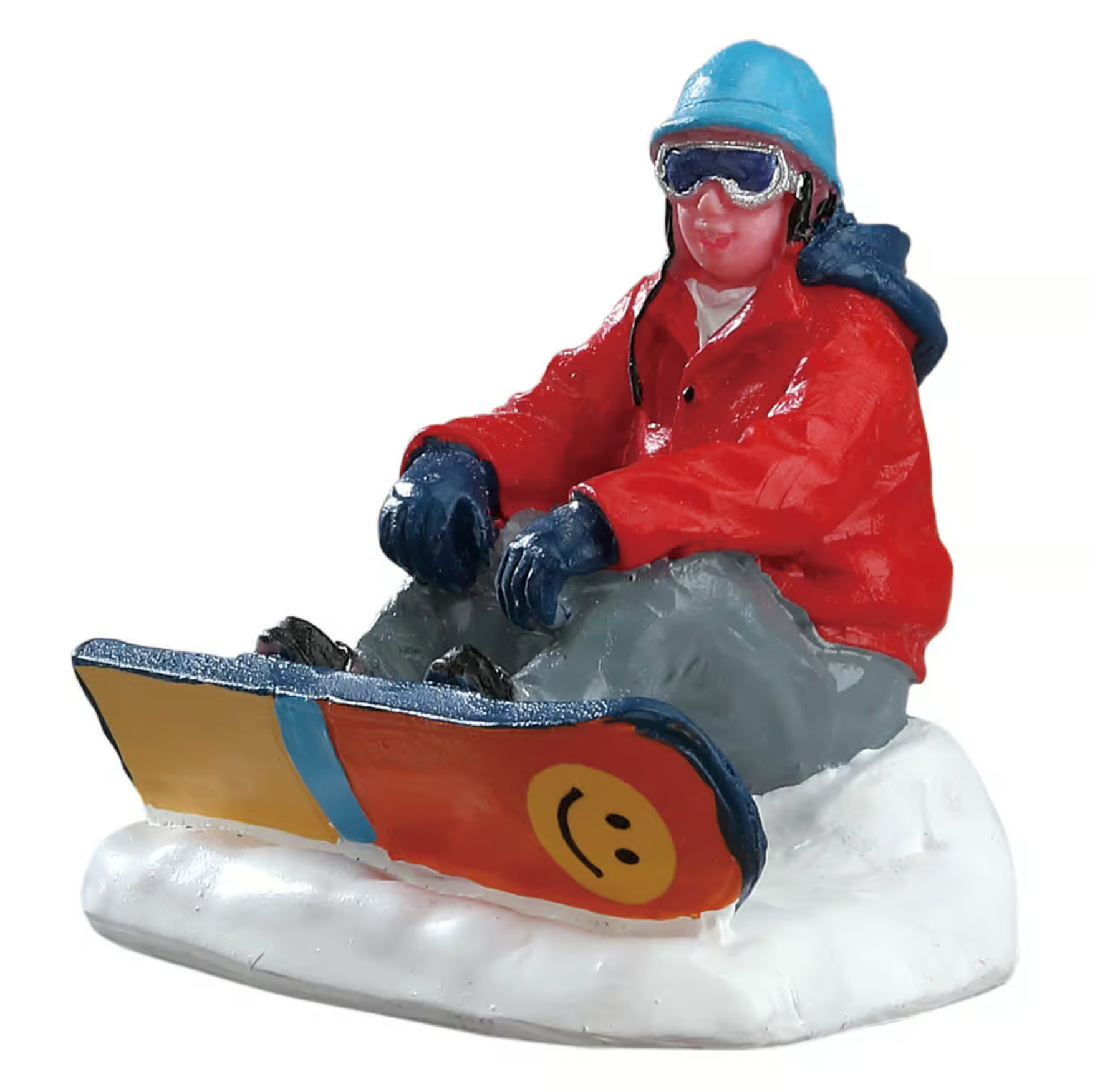 Figurine of a snowboarder in winter gear with a smiley face snowboard on a white background